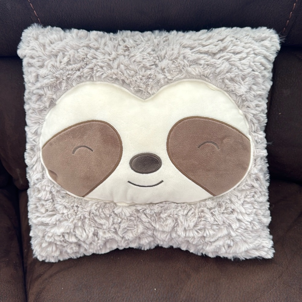 Adorable plush soft sloth pillow. 13 inches horizontal x 12 inches vertical.